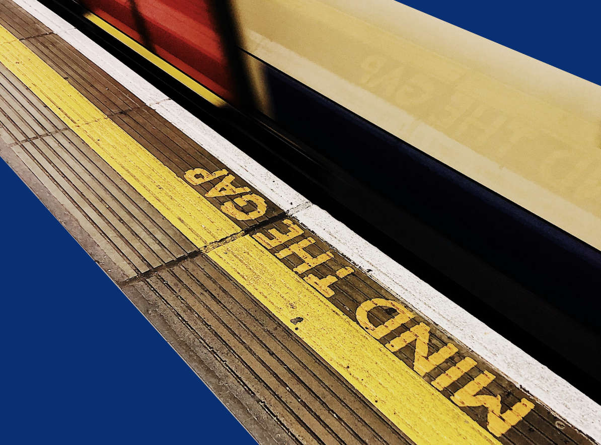 A level boarding train leaving the platform