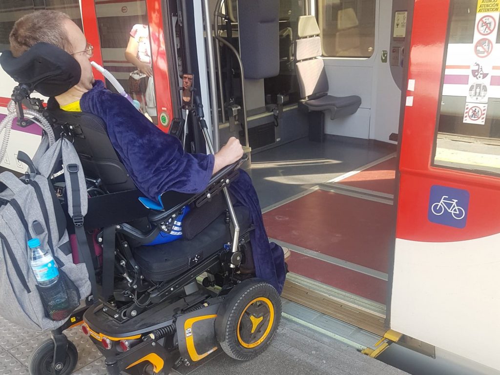 A wheelchair user boarding a train independently